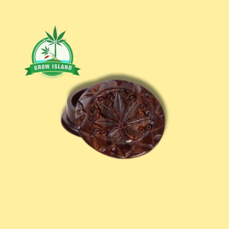 wooden Rosenholz-Grinder in two pieces with creaved cannabis leafs on it and yellow background, and green grow island logo in the left upper corner